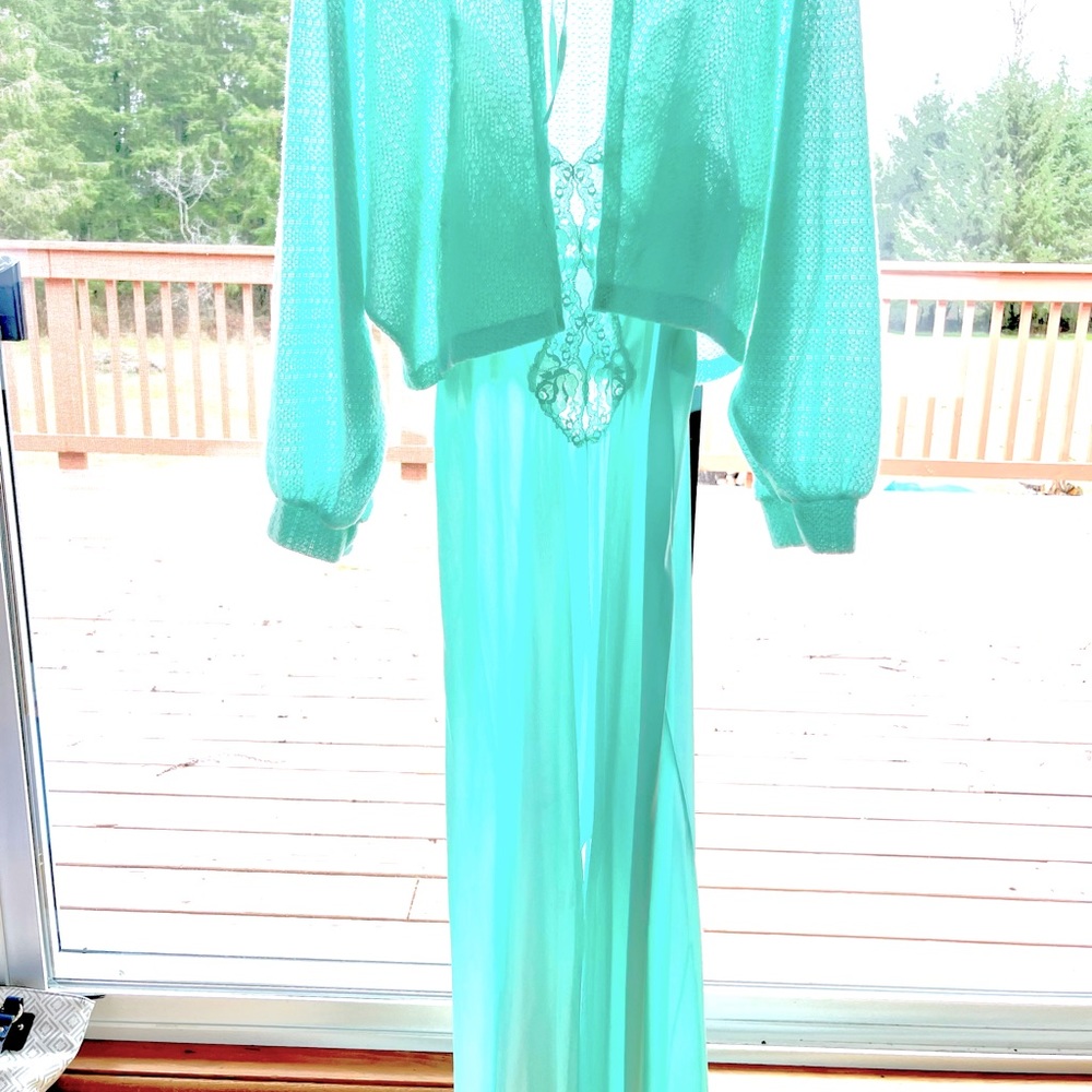 Women’s teal night gown with lace and slit on bottom.